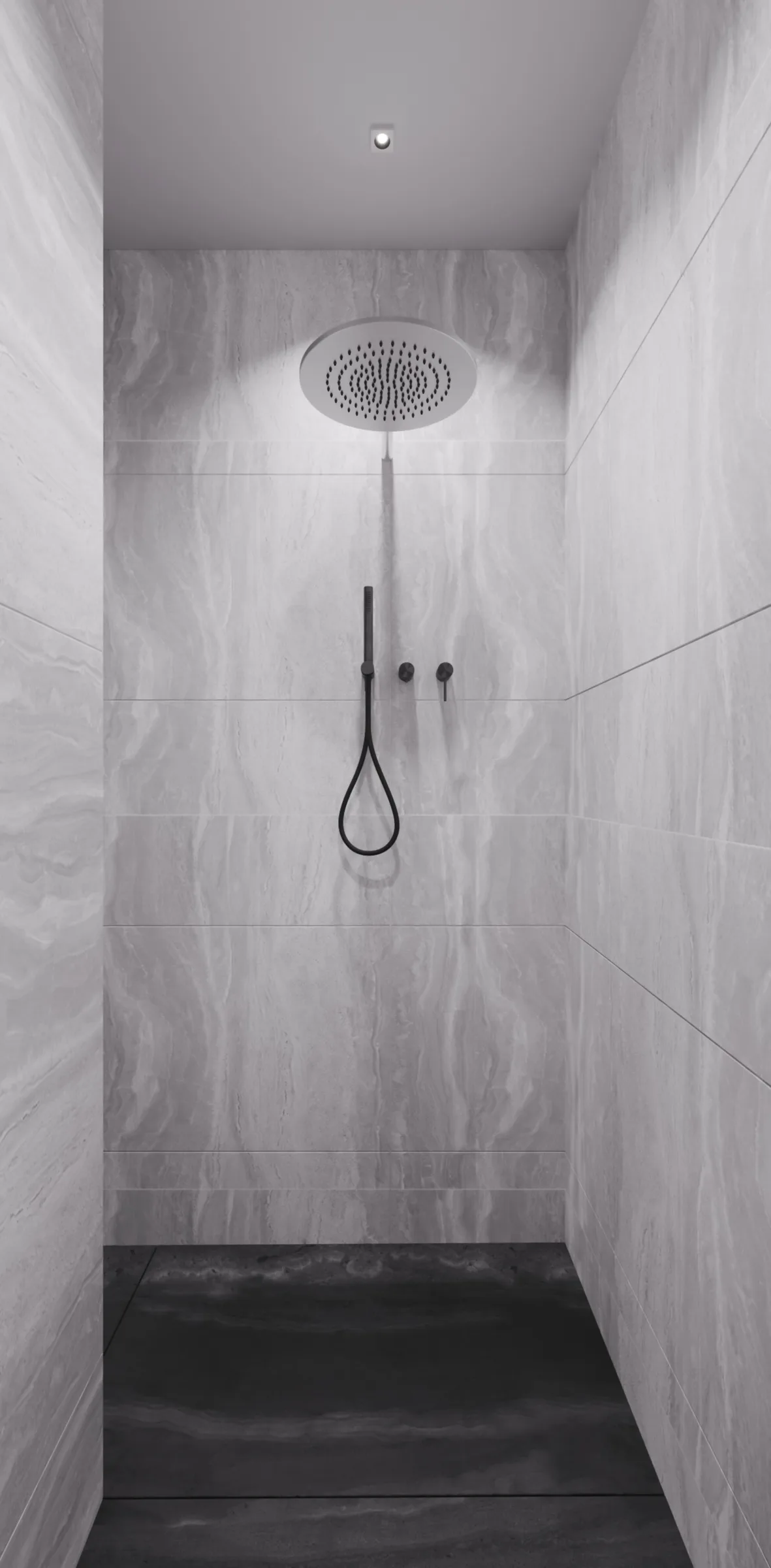 Walk-in shower lined in pale grey stone with a dark floor, oversized rain head and matte black hand shower
