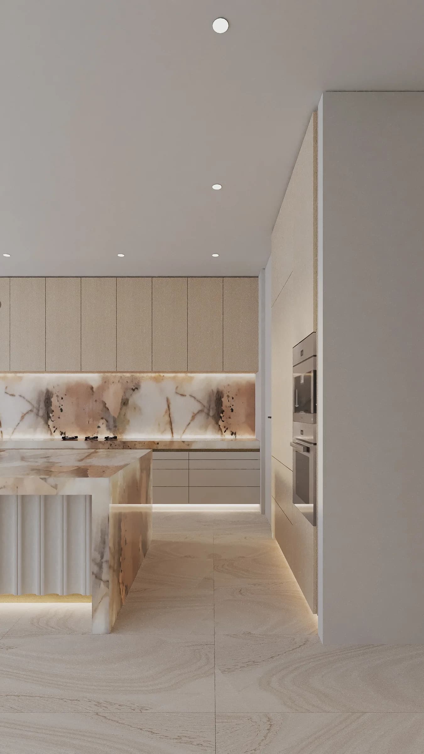 Cream-toned kitchen with rounded cabinetry, a sculpted stone island and warm concealed lighting