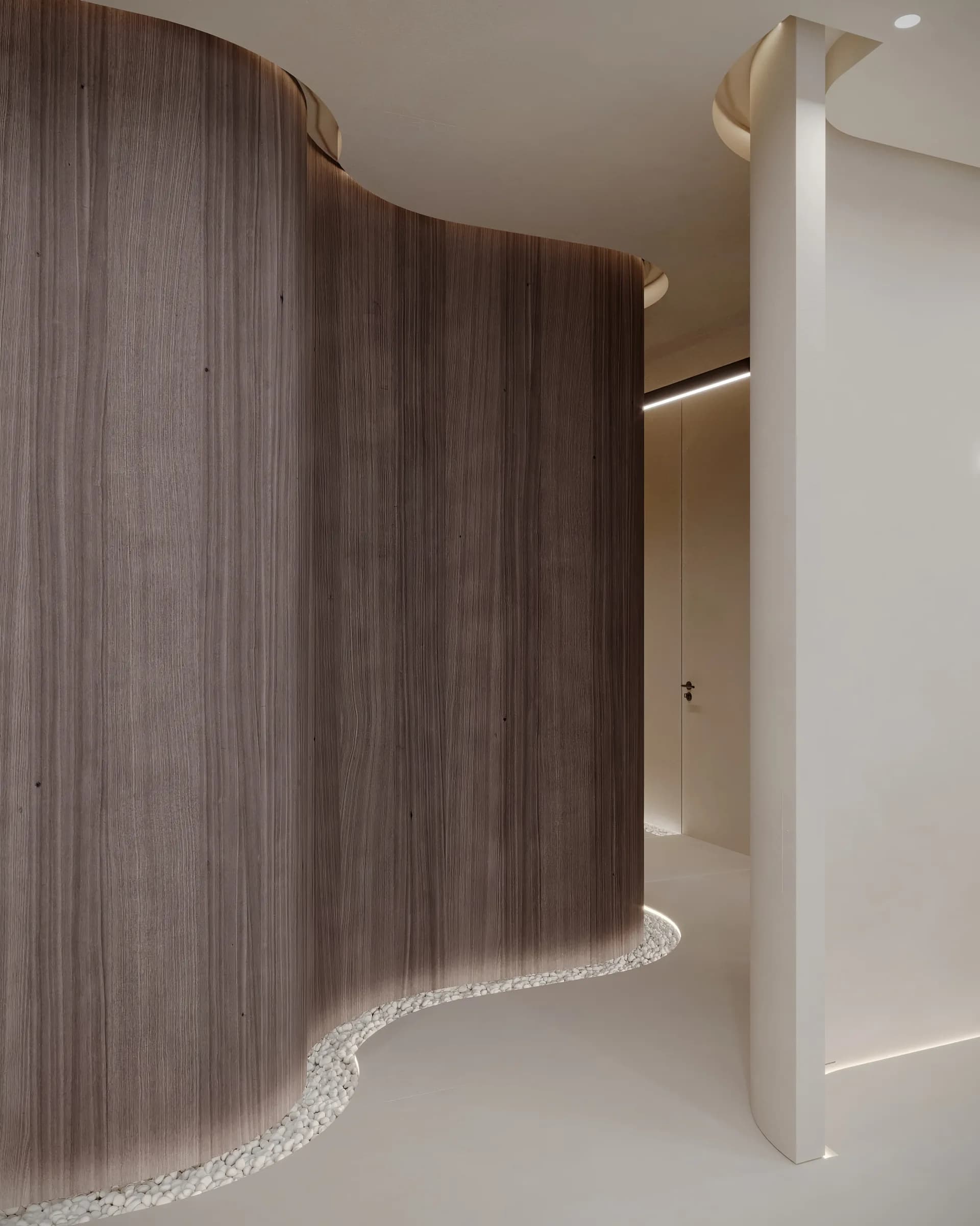 Curving clinic corridor wrapped in dark timber panels, with a white pebble border and concealed floor lighting