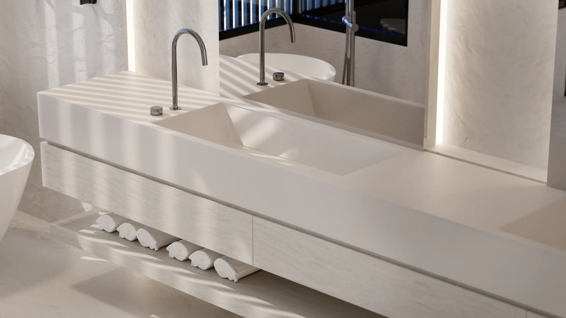 Close view of a floating double vanity with an integrated basin and arched taps