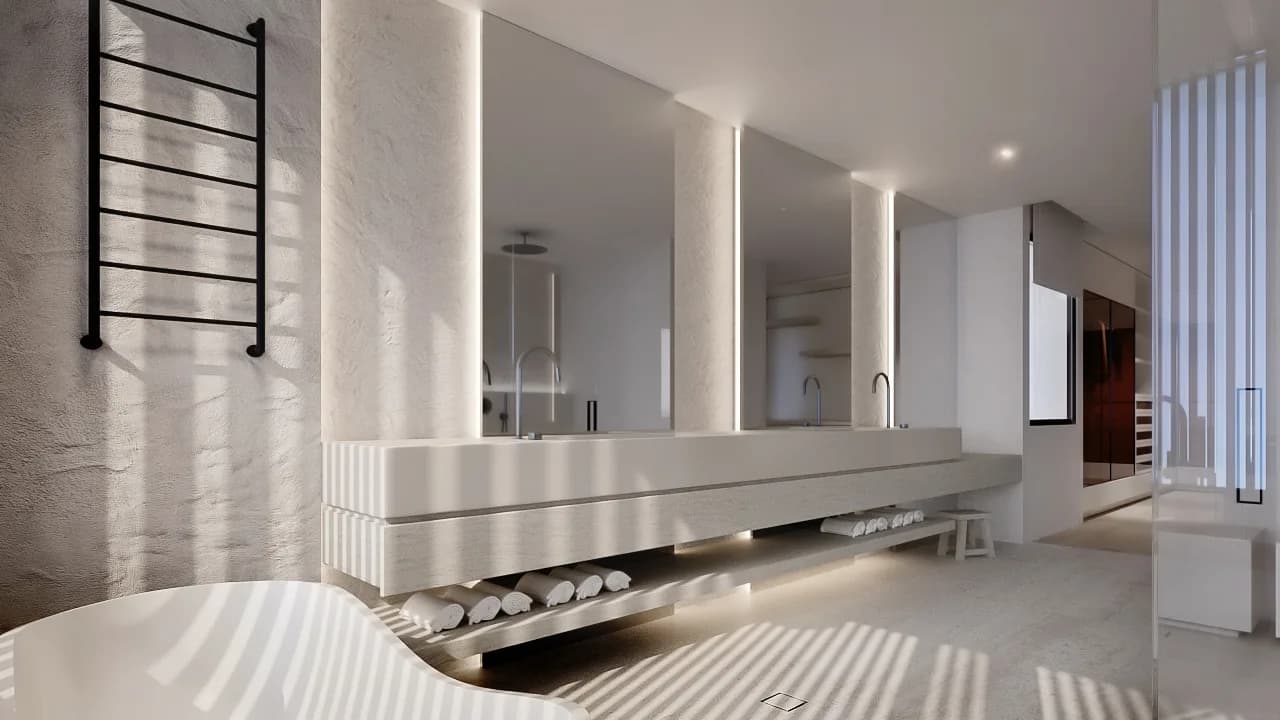 Bathroom with textured cream walls, a floating double vanity, backlit mirrors and a slim black towel rail