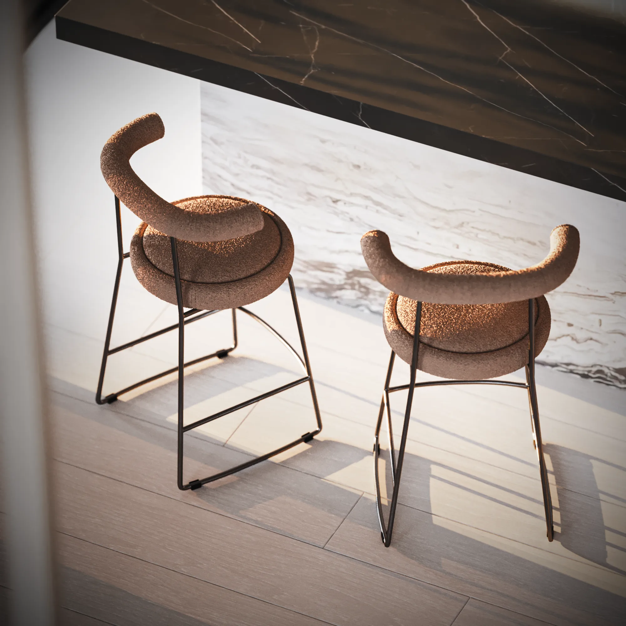 Two sculptural bouclé counter stools on black metal frames beneath a dark stone bench and beside a veined island