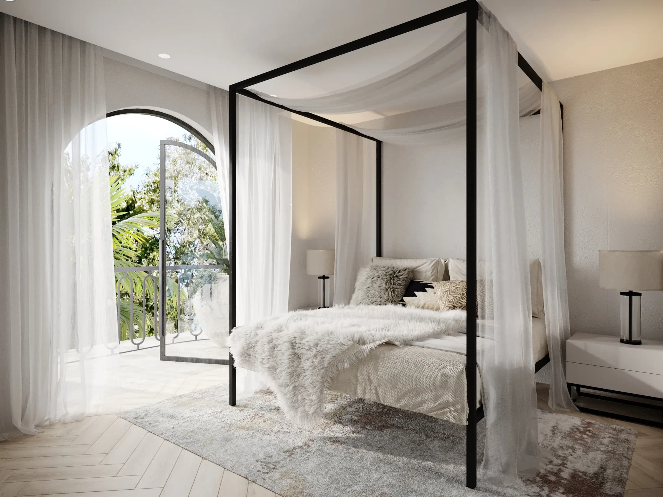 Black four-poster bed draped in sheer fabric beside an arched balcony door, with ivory textiles and a soft rug