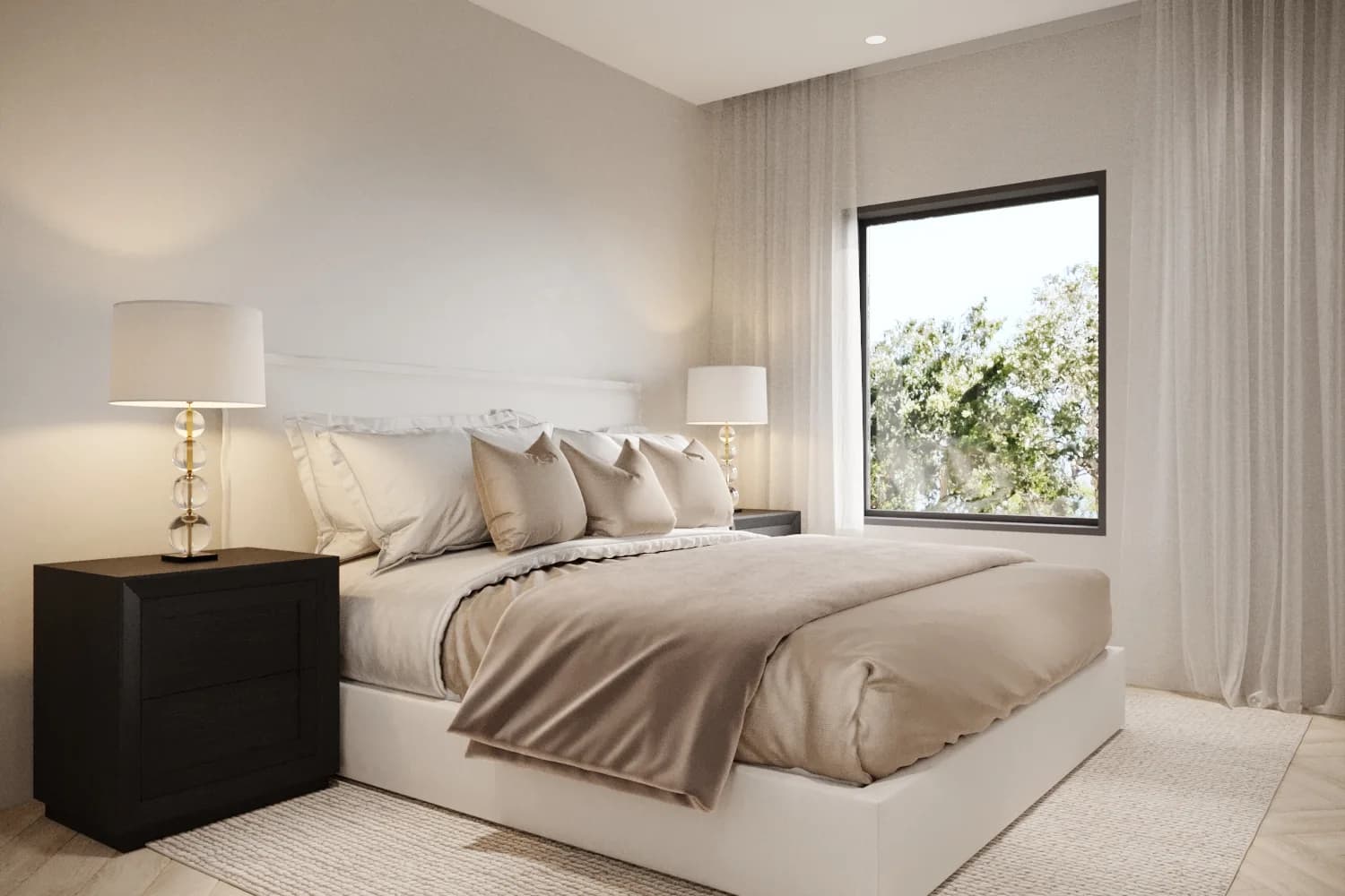 Sunlit bedroom with taupe linen layered over an ivory bed, black timber drawers and a broad tree-framed window