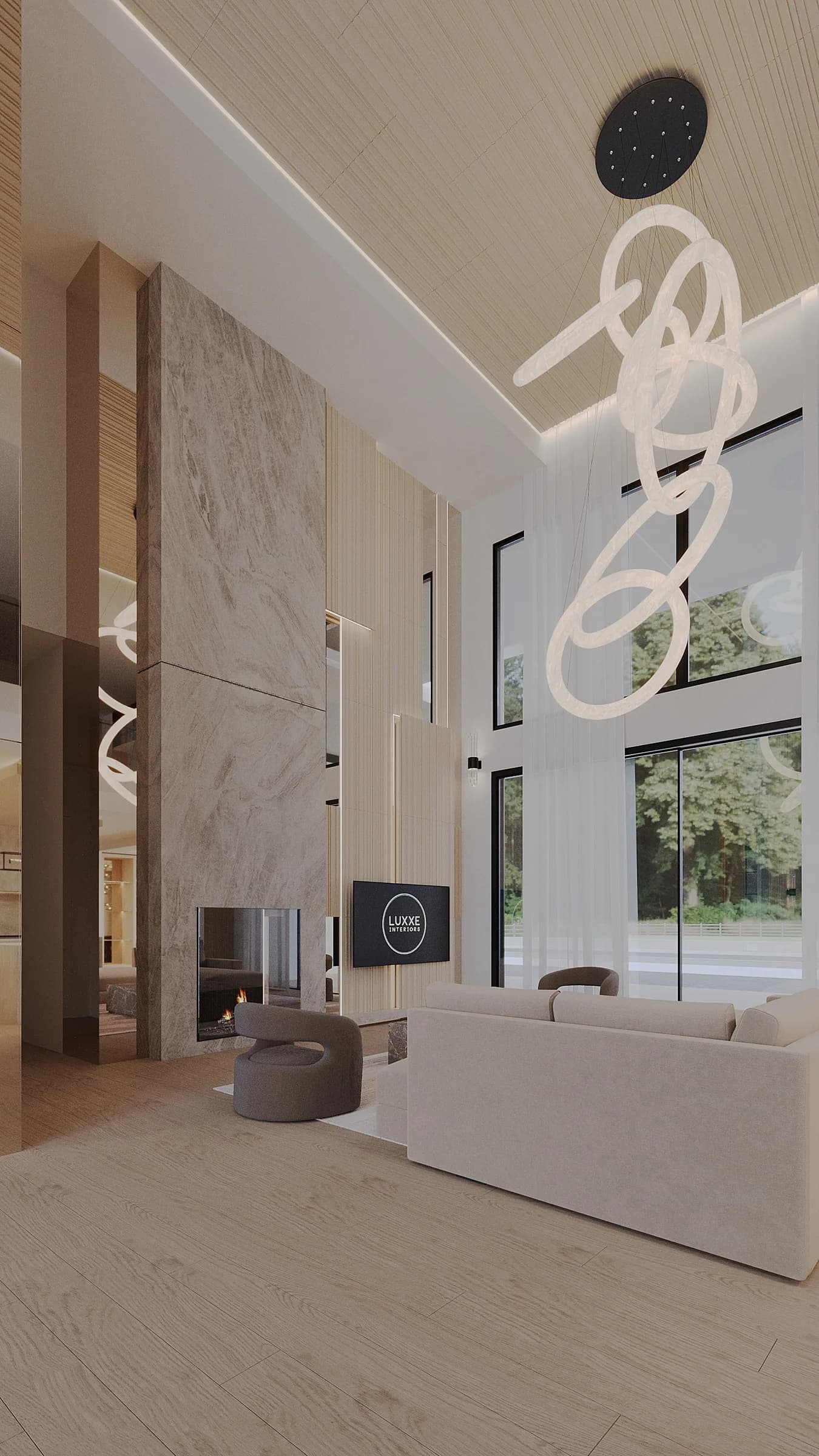 Double-height living room with a monolithic stone fireplace, pale sofas and a cascading ring chandelier