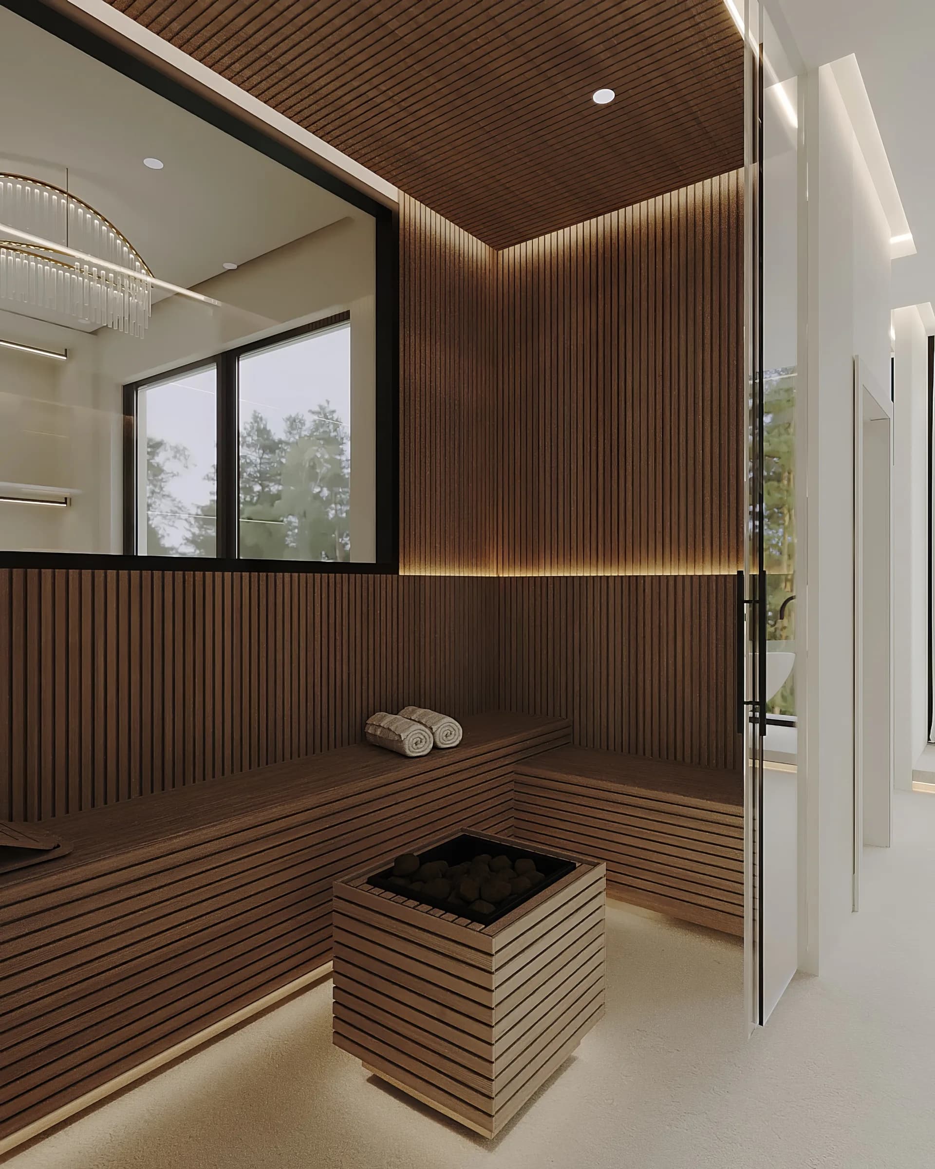 Timber-lined sauna with wraparound benches, concealed lighting and a central stone-filled heater