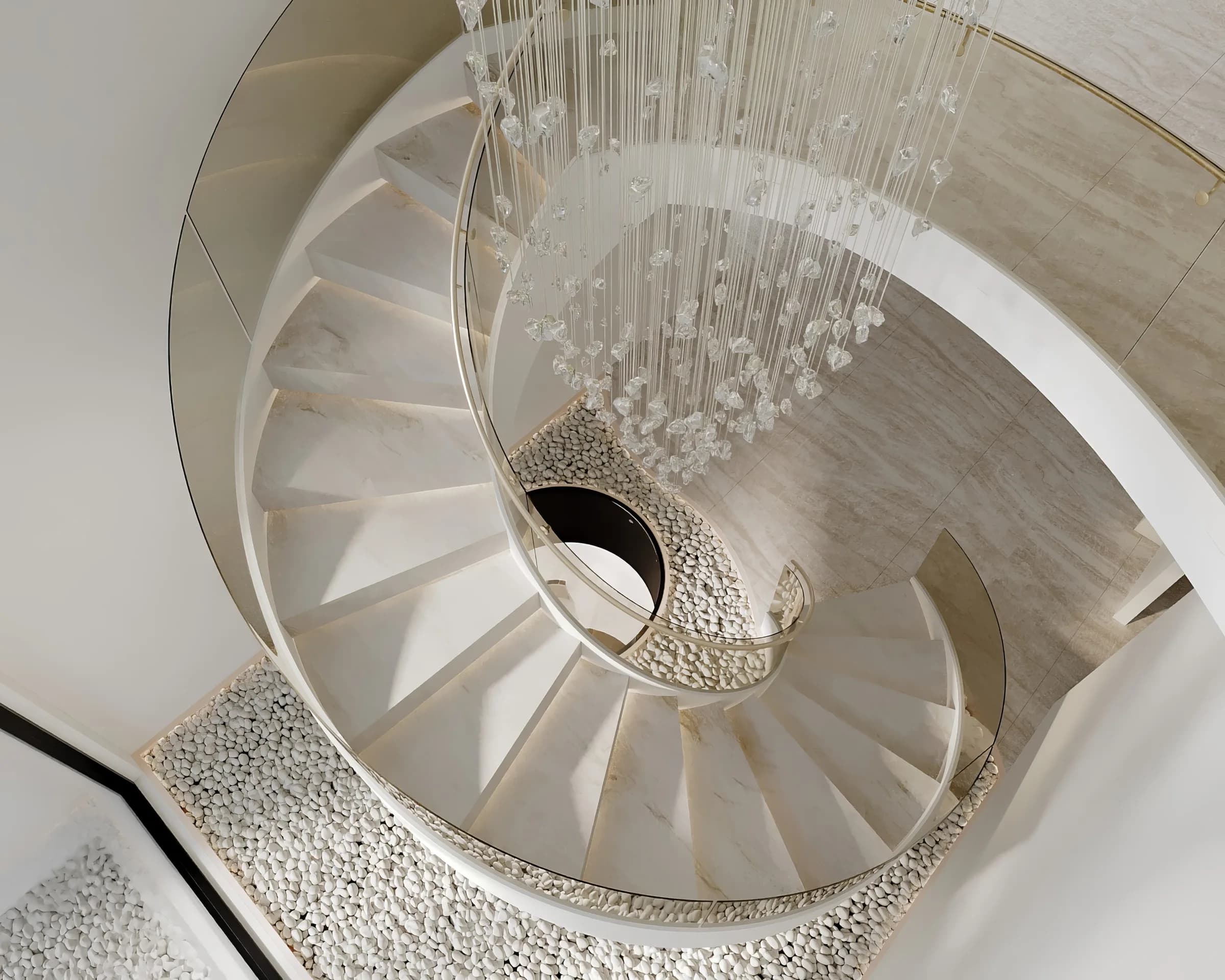 Spiral staircase in pale stone with a glass balustrade, brass handrail and crystal cascade over white pebbles