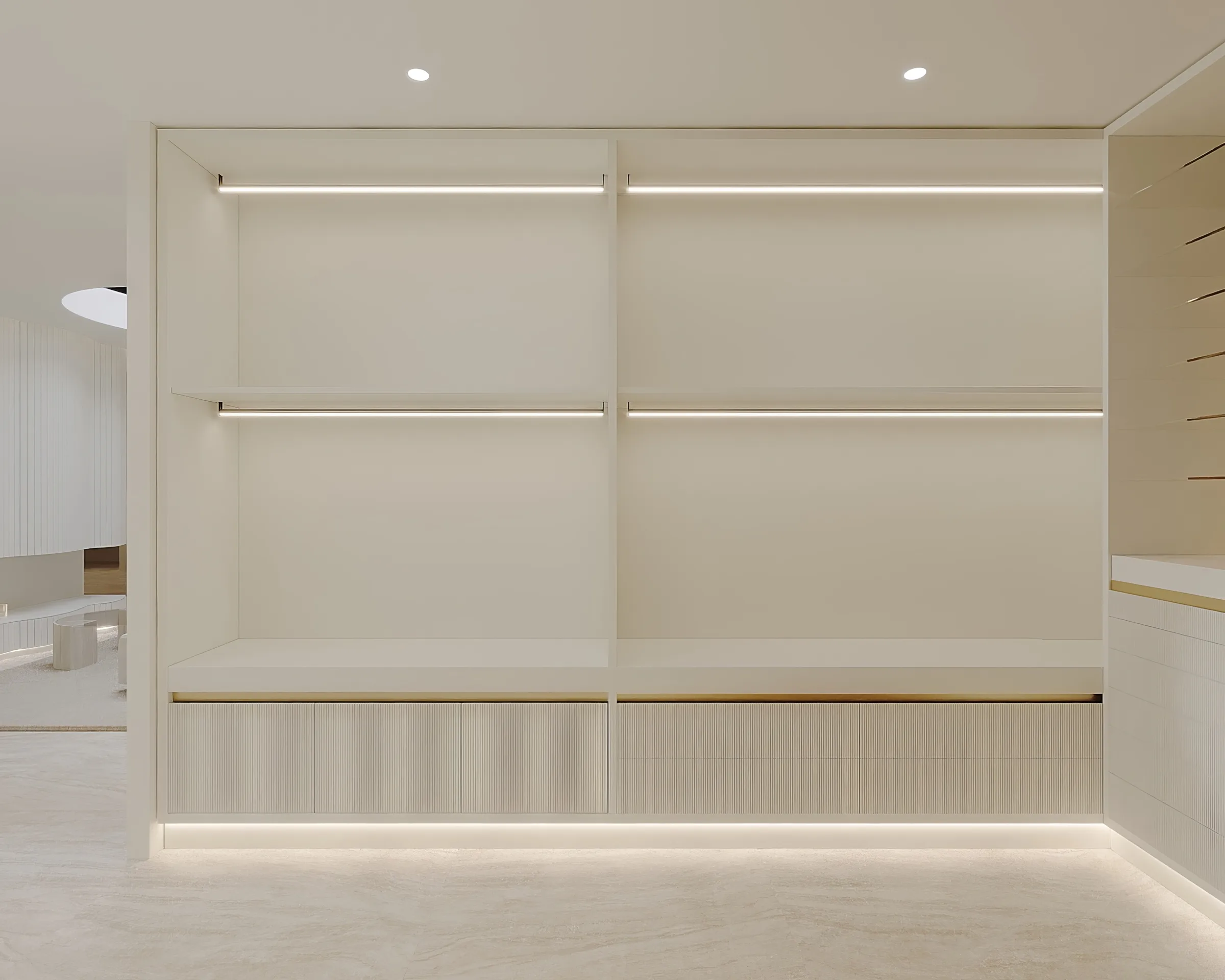 Ivory dressing room wardrobe wall with fluted drawers, slim brass detailing and illuminated open hanging rails