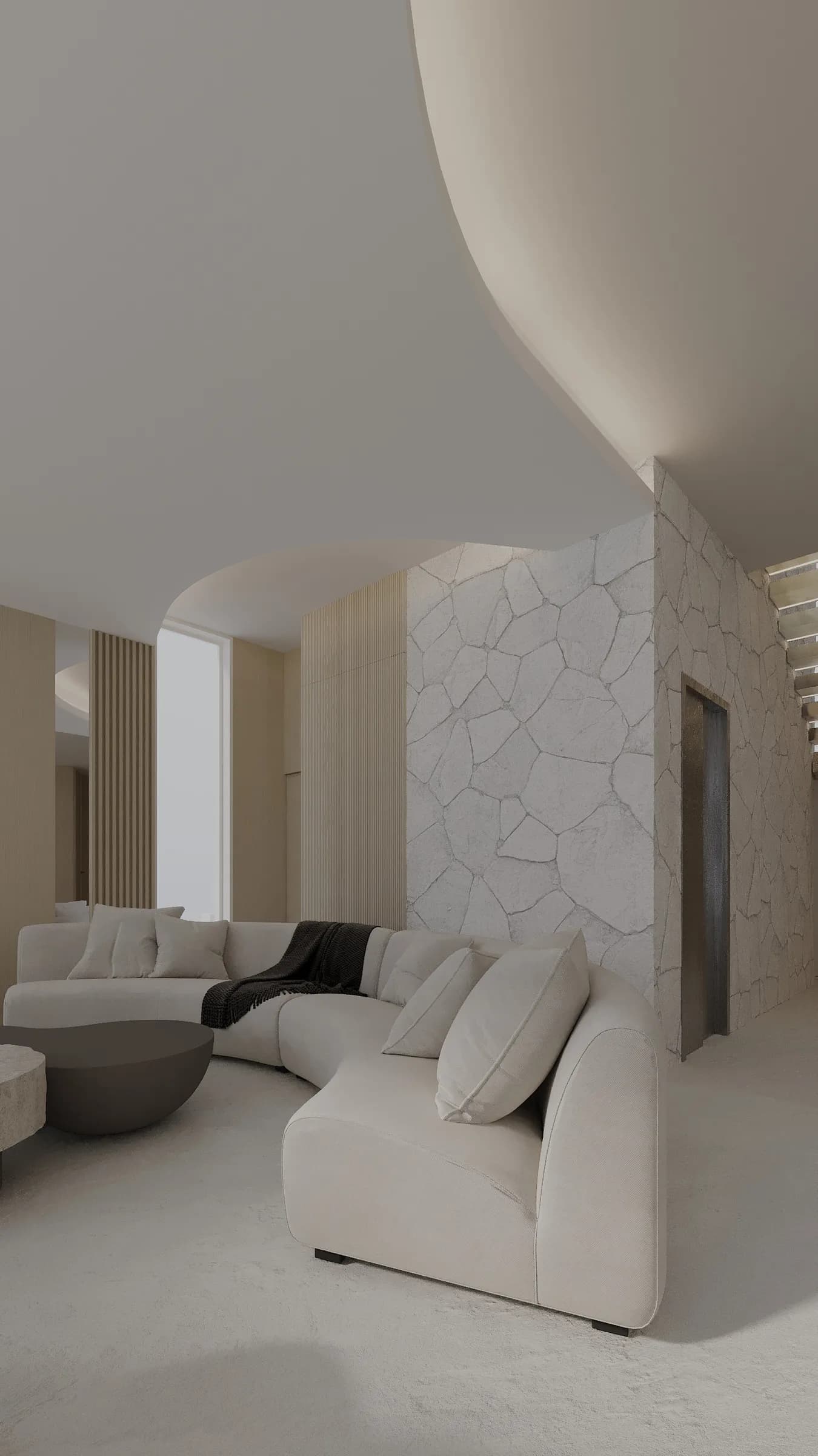 Sculptural cream sectional and round coffee tables sit beneath a sweeping ceiling beside a pale stone-clad wall