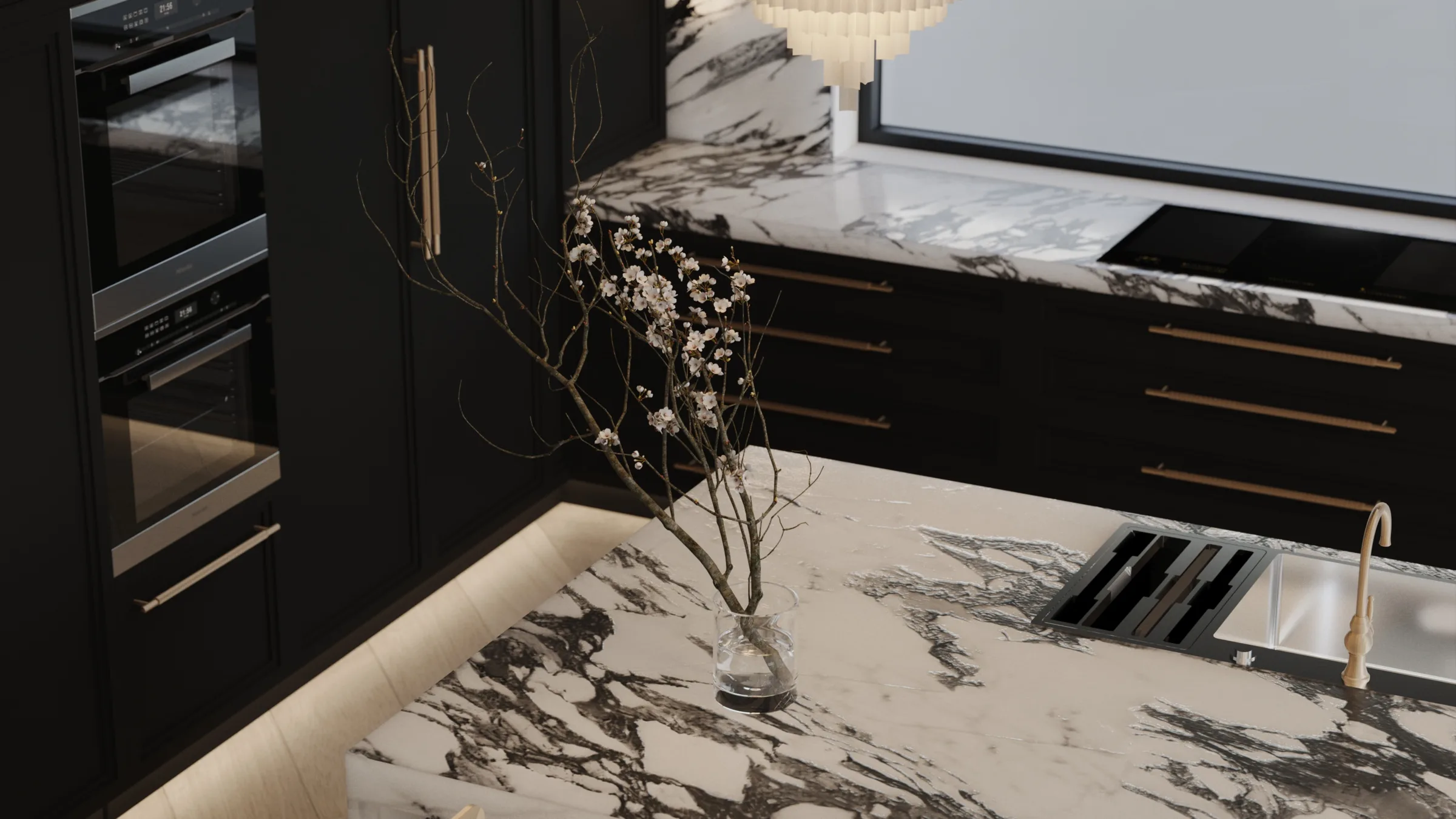 Close view of dramatic black-veined marble with matte black cabinetry and brass