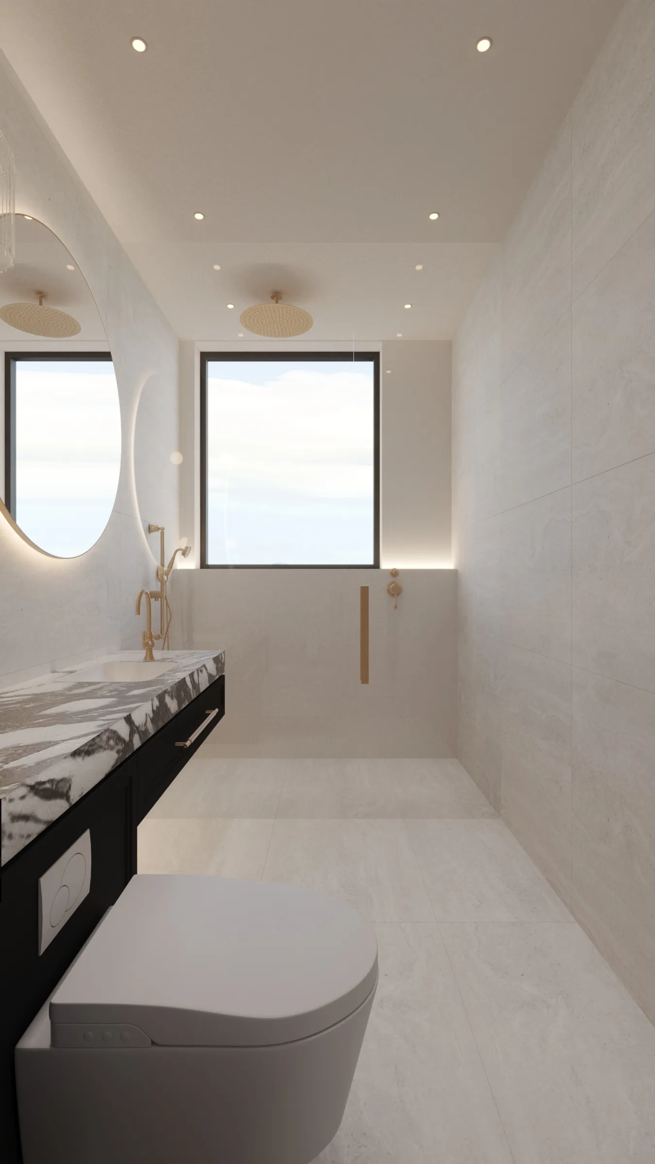Light-filled bathroom lined in pale stone, with a veined marble vanity, oval mirror and brushed brass shower fittings