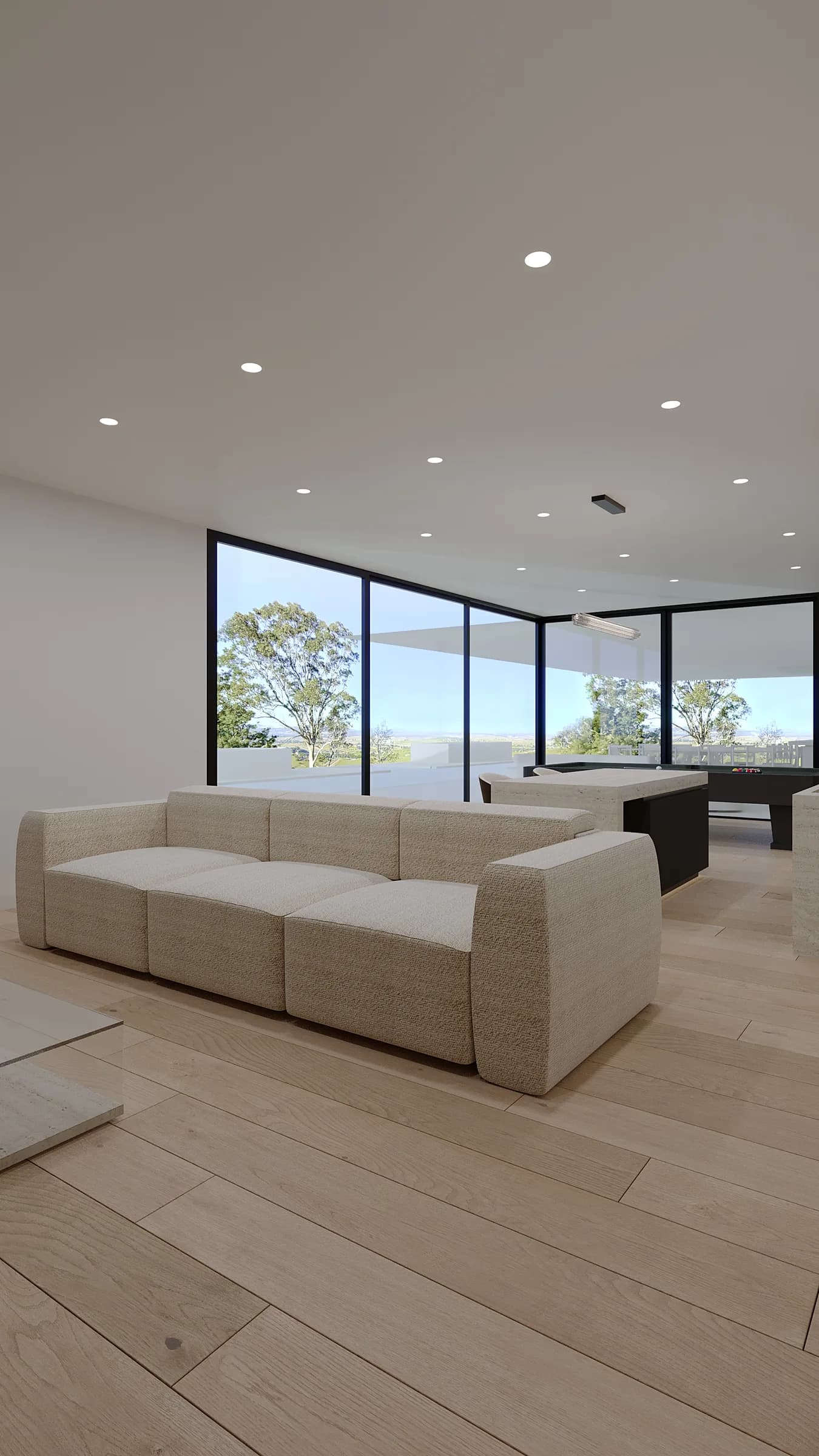 Relaxed games lounge with a cream bouclé sofa, pale timber floor and pool table framed by panoramic corner glazing
