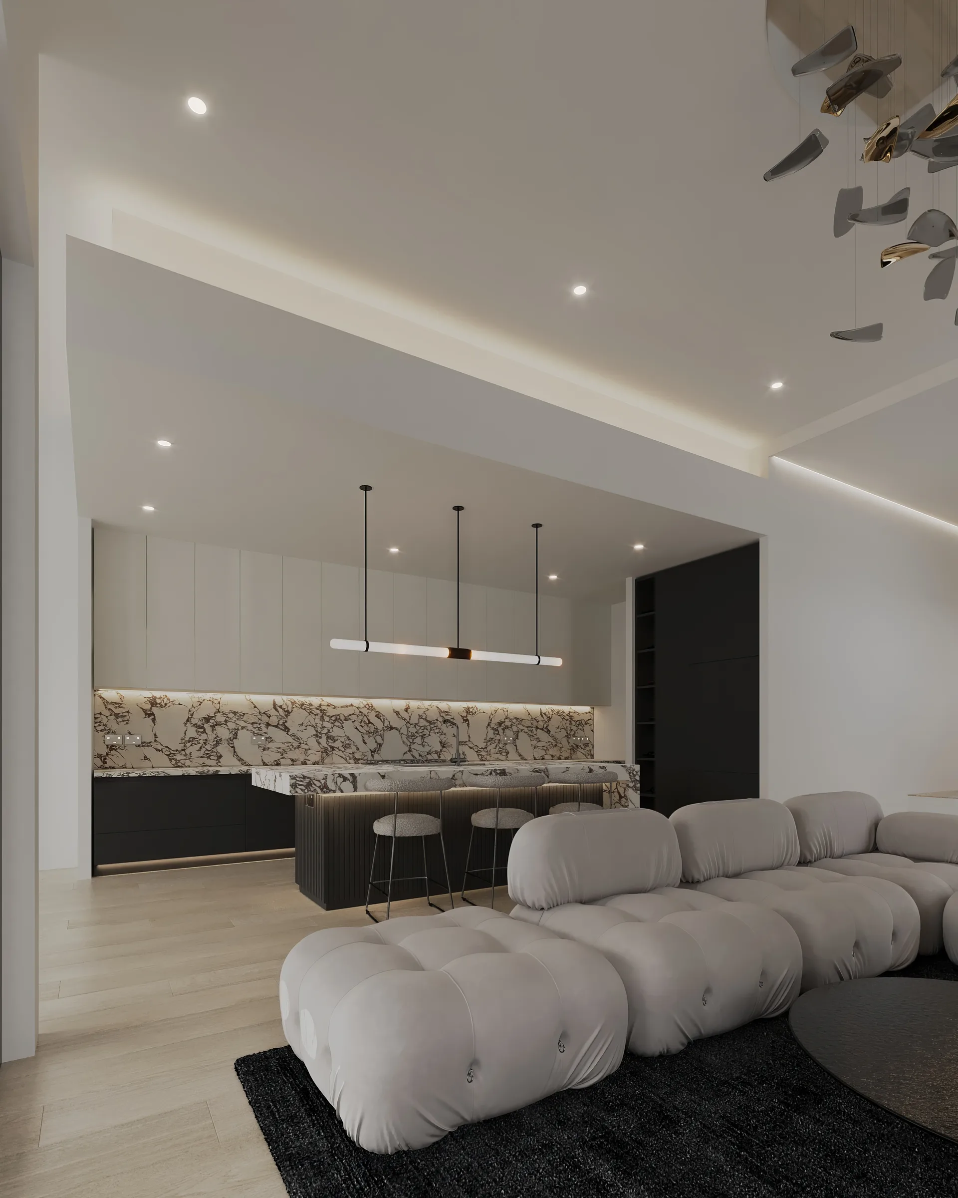 Ivory modular sofa facing a black and veined stone kitchen beneath layered linear ceiling lighting