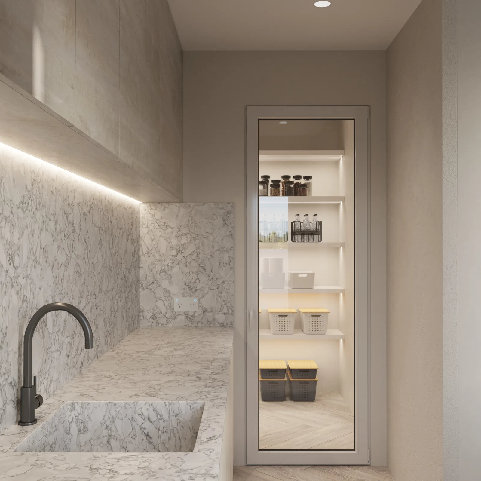 Compact butler's pantry with grey-white stone surfaces, black tapware and an illuminated storage cupboard