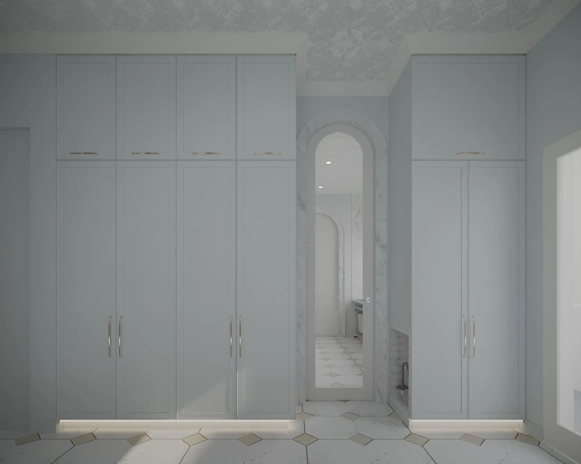 Pale blue dressing room with floor-to-ceiling wardrobes framing a tall marble-trimmed arched mirror