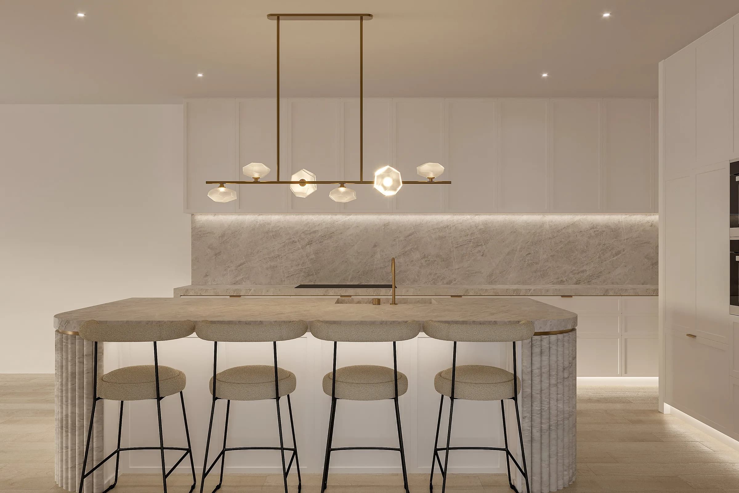 Front view of the kitchen island with fluted stone ends, bouclé stools and a brass pendant against pale cabinetry
