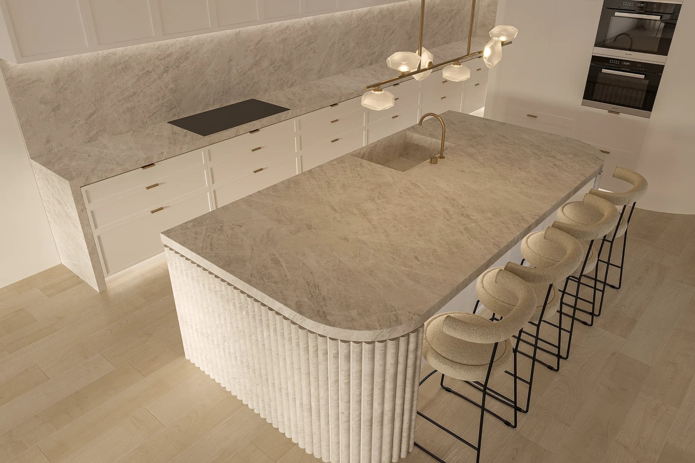 Elevated kitchen view highlighting the broad veined stone island, integrated sink and rounded fluted corner