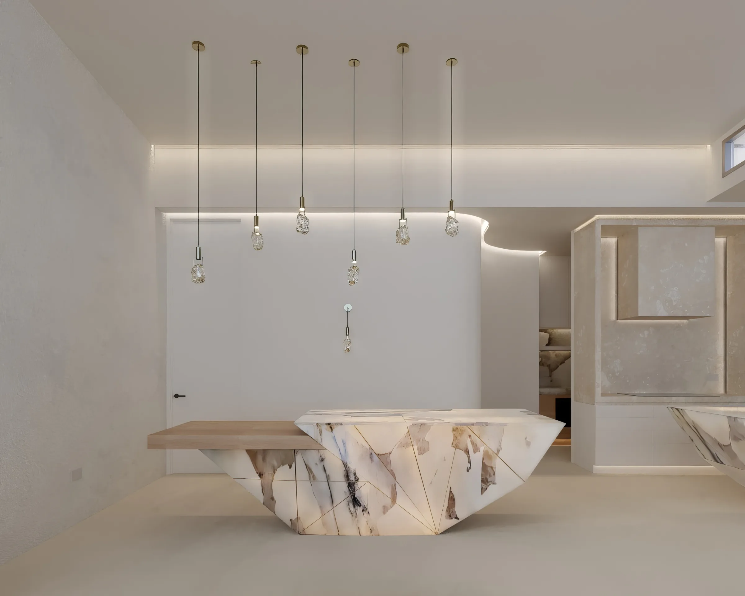 Pale minimalist kitchen with an angular marble island, oak bench and concealed ceiling wash behind crystal pendants